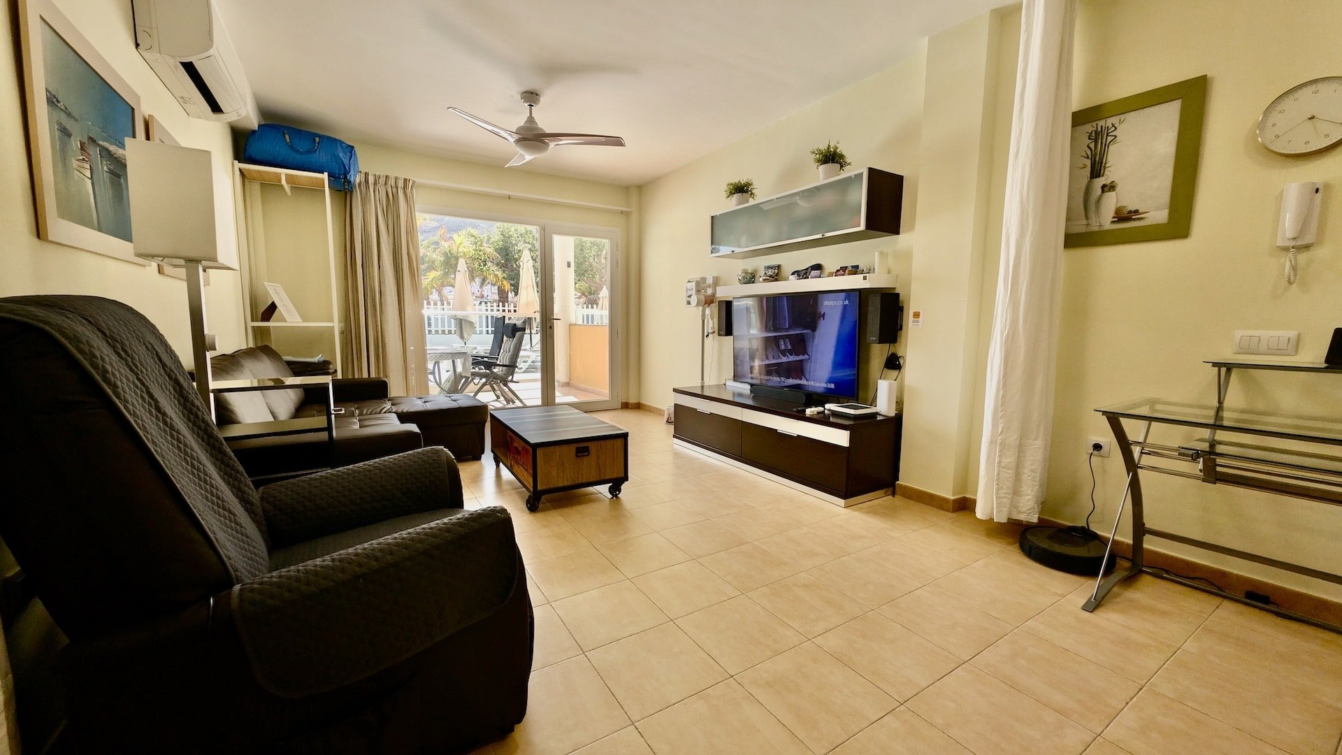 Lounge and living area inside Golden Beach Apartment with seating and terrace doors